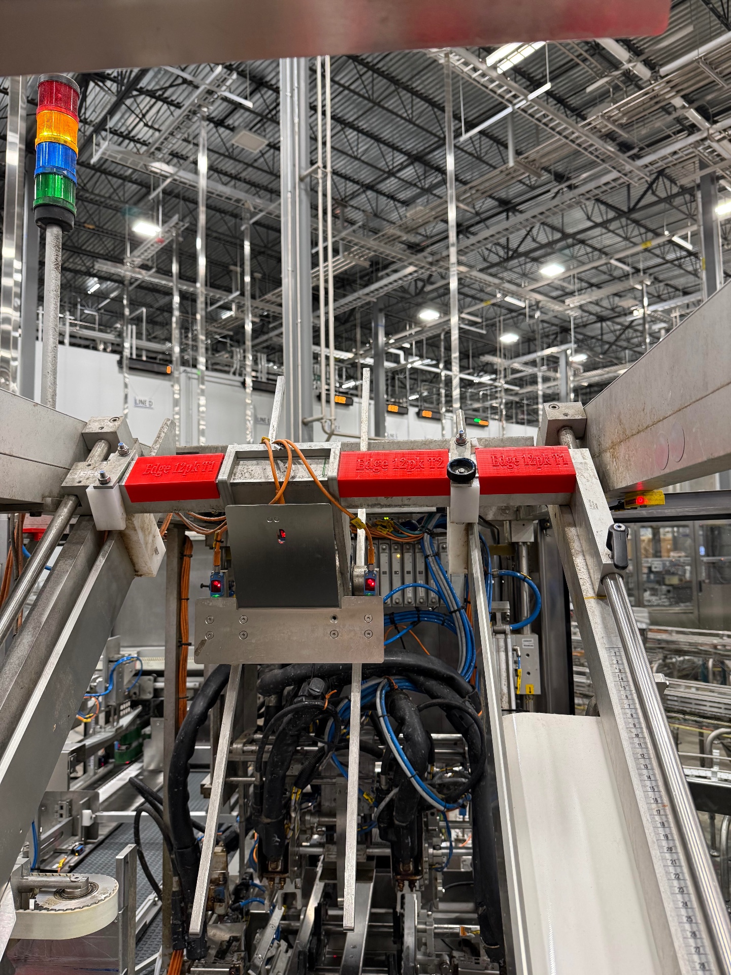 Red cylindrical jigs on production rail