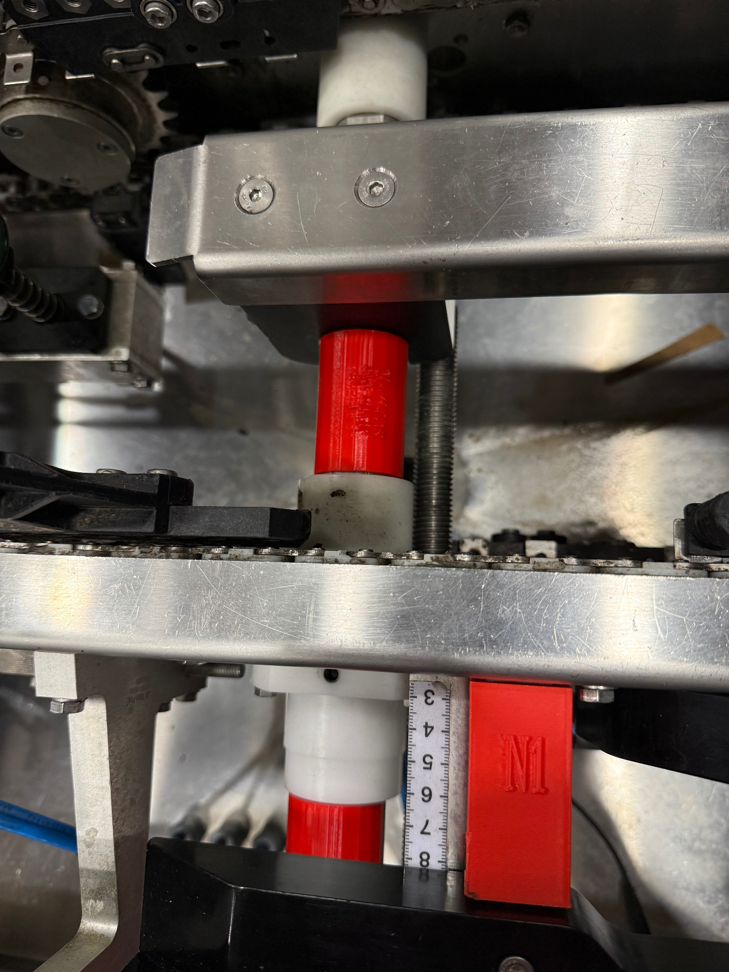 Multiple red 3D jigs labeled T1 T2 T3 across production line